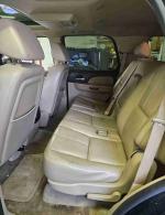 Interior view of a 2007 Chevrolet Tahoe LT with beige leather seats and third row seating.