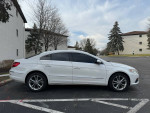 Side view of a 2009 Volkswagen CC Luxury FWD, white sedan with tinted windows, parked in a lot.