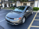 2008 Honda Civic LX coupe in gray parked outside with clear sky and maintained appearance