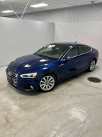 2018 Audi A5 Premium Plus in scuba blue metallic, showcasing its sleek design and luxurious features.