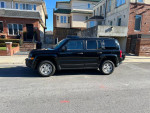 2015 black Jeep Patriot Sport parked on a street, featuring a clean title and 101k miles.