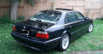 2001 BMW 740iL in pristine condition, showcasing a sleek black exterior and well-maintained details.