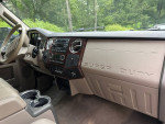 Interior view of a 2010 Ford F350 Super Duty Dually with gear shifter, dashboard, and audio controls.