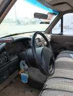 Interior view of a 1996 Ford F350 service truck with a steering wheel and dashboard details.