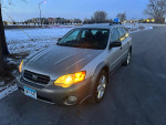 2007 Subaru Outback parked in winter scenery, showcasing its design and newer winter tires.