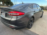 2018 Ford Fusion in gray, showing rear view with sleek design and low mileage features.