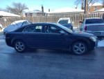 2011 Chevrolet Malibu in good condition parked, with snow on nearby vehicles, reliable transportation for sale.