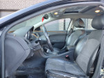 Interior view of a 2011 Chevrolet Malibu showing leather seats and sunroof, ready for reliable transportation.