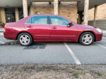 2006 Honda Accord EXL in maroon with gray leather interior parked, featuring alloy wheels and moonroof.