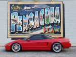 1996 Acura NSX T in front of a colorful mural in Pensacola, showcasing a modified sports car in urban setting.