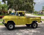 1955 Chevrolet 3100 4x4 pickup truck in yellow parked on a residential street