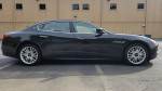 2014 Maserati Quattroporte S Q4 in black, side view, showcasing its elegant design and premium alloy wheels.