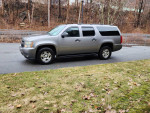 2007 Chevy Suburban 4X4 parked on a road, well-maintained, with minimal rust and great performance.