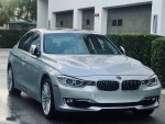 2015 BMW 335 XI AWD in Frozen Silver Metallic with black leather interior, showcasing a luxury car's exterior.