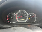2009 Subaru Impreza Outback Sport dashboard with 185,479 miles shown and gauges in focus.