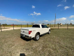 2013 Ford F150 Lariat 4X4 parked in a rural setting, showcasing its excellent condition and styling.