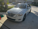 2009 Genesis Sedan with low mileage, excellent condition, and stylish white exterior.