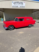 1955 Chevy Sedan Delivery in bright red color, showcasing modern restoration and custom features.
