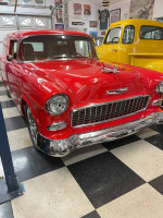 1955 Chevy Sedan Delivery, fully restored with LT1 motor and new transmission, showcased in a garage setting.