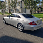 Mercedes-Benz CLS 550 in brilliant silver parked on a residential street, showcasing a sleek design and low mileage.