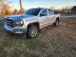 GMC Sierra 1500 pickup truck for sale, featuring a silver exterior and black leather interior.