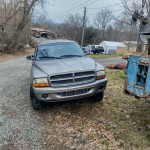 2000 Dodge Durango SLT for sale in a rural setting, features new tires and third-row seating.