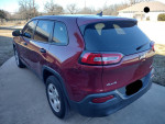 2014 Jeep Cherokee Sport FWD parked, showcasing clean design and reliable features with 143,000 miles.