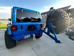 Rear view of a Hydro Blue Jeep Rubicon 392, showcasing large tires and upgraded features.