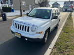 2014 Jeep Patriot parked on the street, showcasing its reliable design and well-maintained condition.