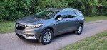 2021 Buick Enclave Preferred SUV parked on a country road, featuring a sleek design and spacious interior.