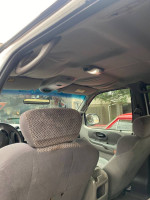 Interior view of a 2002 Ford F-150 quad cab showing seats and overhead features.