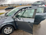 2013 Chevrolet Sonic LT Hatchback with open door and new tires, showcasing exterior condition.