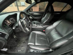 Interior view of a 2018 Infiniti Q50 AWD with black leather seats and advanced dashboard features, 92000 miles.