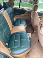 Interior view of a 1997 Jeep Cherokee showing well-maintained rear seats with new covers and good condition.