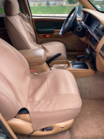 Interior of 1997 Jeep Cherokee showing front seats and dashboard, featuring functional and well-maintained components.