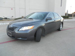 2009 Toyota Camry LE in gray, one owner, features gray leather interior, automatic transmission, 122,000 miles.