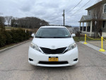 Front view of a well-maintained 2011 Toyota Sienna LE AWD parked in a residential area