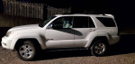 2005 Toyota 4Runner SR5 4WD in white parked at night, showcasing its design and features.