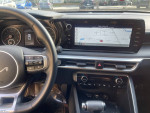 Interior view of a 2023 Kia K5 GT with dashboard display and steering wheel showcasing low mileage of 11,647