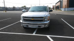 Front view of 2012 Chevrolet Silverado 1500 LT 4WD parked, showcasing its chrome grille and headlights.