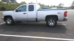 2012 Chevrolet Silverado 1500 LT 4WD in silver, side view showing extended cab and chrome wheels