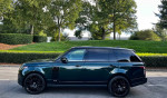 2019 Land Rover Range Rover Supercharged in rare SVO green with 22-inch wheels, parked on a scenic street.