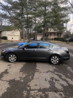 2008 Honda Accord parked on a residential street, showcasing its excellent condition and classic design.