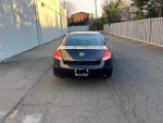 2008 Honda Accord LX coupe in black parked on a quiet street, showcasing its rear view and clean condition.
