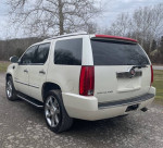 2007 Cadillac Escalade SUV with chrome wheels, backup camera, and tinted windows parked outdoors