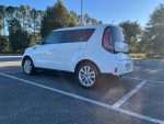 2019 Kia Soul in white with black interior parked in a sunny lot, showcasing the car's features.