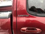 Close-up of the Limited badge on a 2006 Toyota Tundra truck in red color.