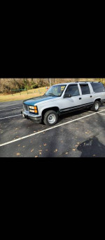 1994 GMC Suburban parked on a road, great condition, ideal for winter driving and reliable performance.