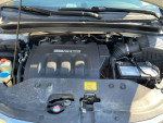 Engine compartment of a 2010 Honda Odyssey EX FWD with low mileage and well-maintained components.