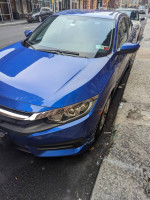 2016 Honda Civic LX in blue color, parked on the street, showcasing a compact design and excellent condition.
